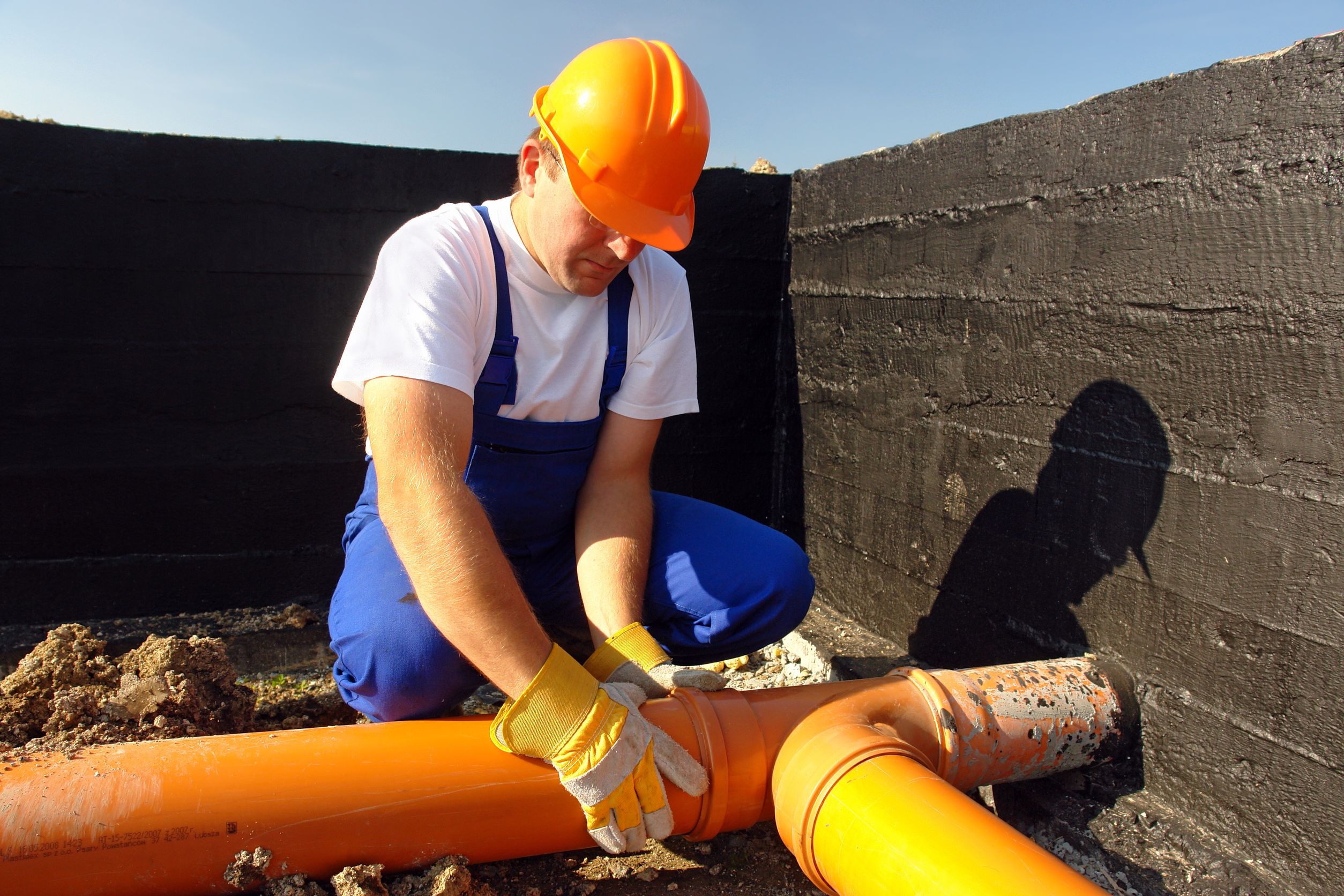 4192819_l-Plumber-assembling-pvc-sewage-pipes-in-house-foundation